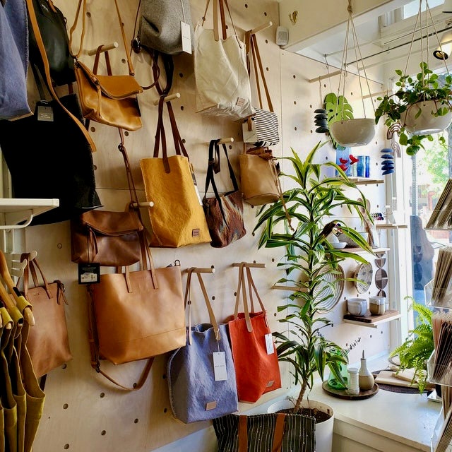 Modern Wooden Pegboard Wall Display for Home Organization and Retail Merchandising