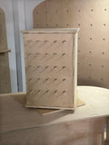 Spinning birch plywood jewelry and earring display stand with diagonal peg slots, CNC cut in our shop — tabletop or countertop design for retail pop-up booths and craft fairs