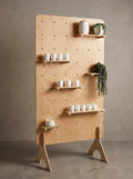 Freestanding birch plywood pegboard display with adjustable shelves and hooks, CNC cut in our shop — updated hero photo