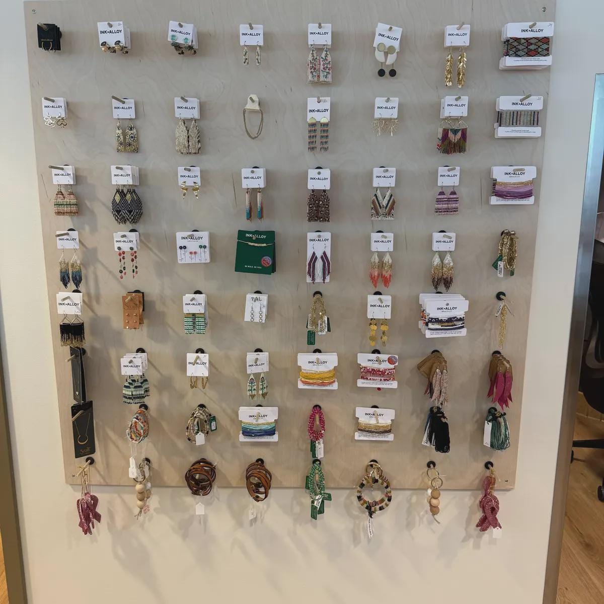 Modular birch plywood wall pegboard with shelves shown in home organization setup, CNC cut in our shop