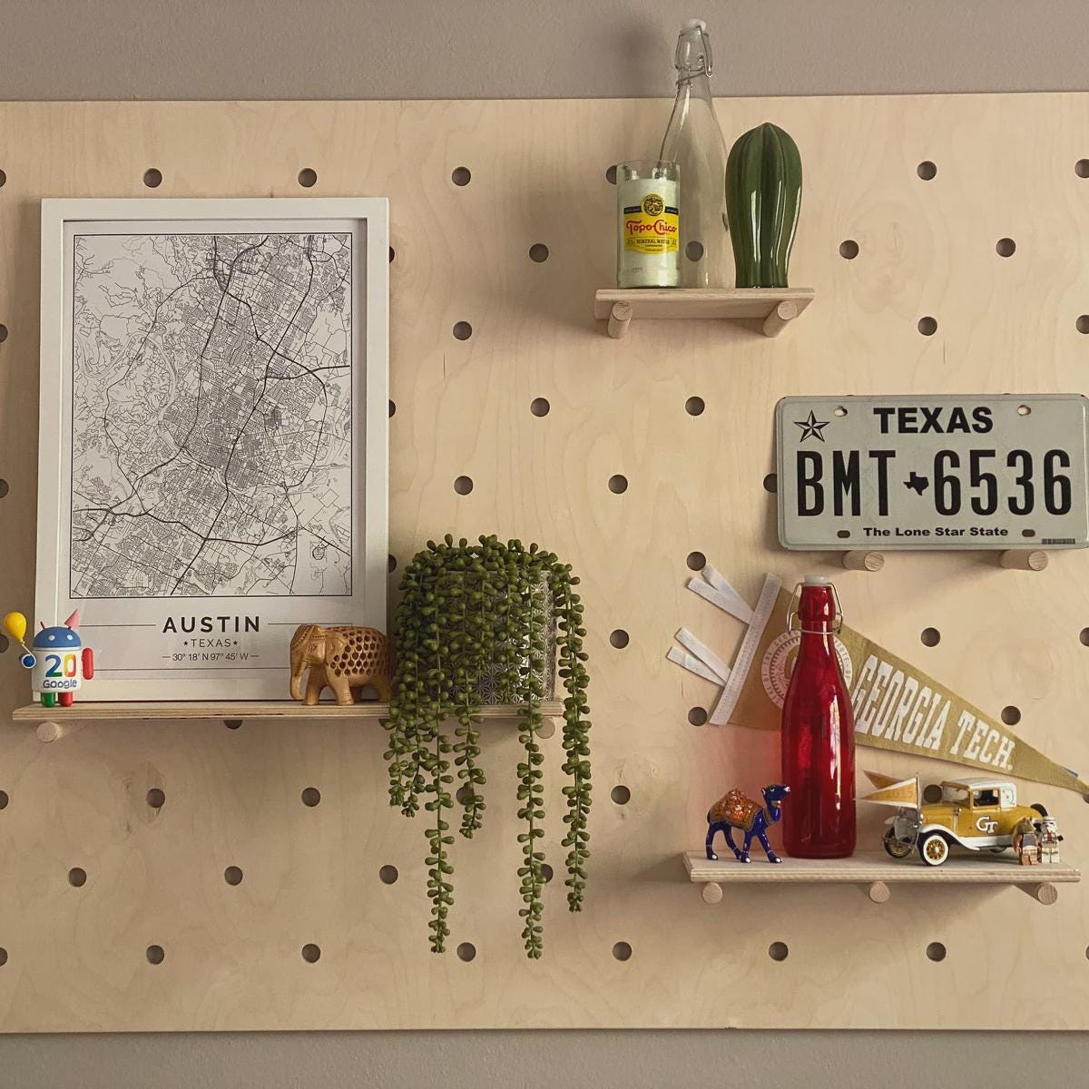 Modern wood pegboard wall with modular shelves displaying products, CNC cut in our shop