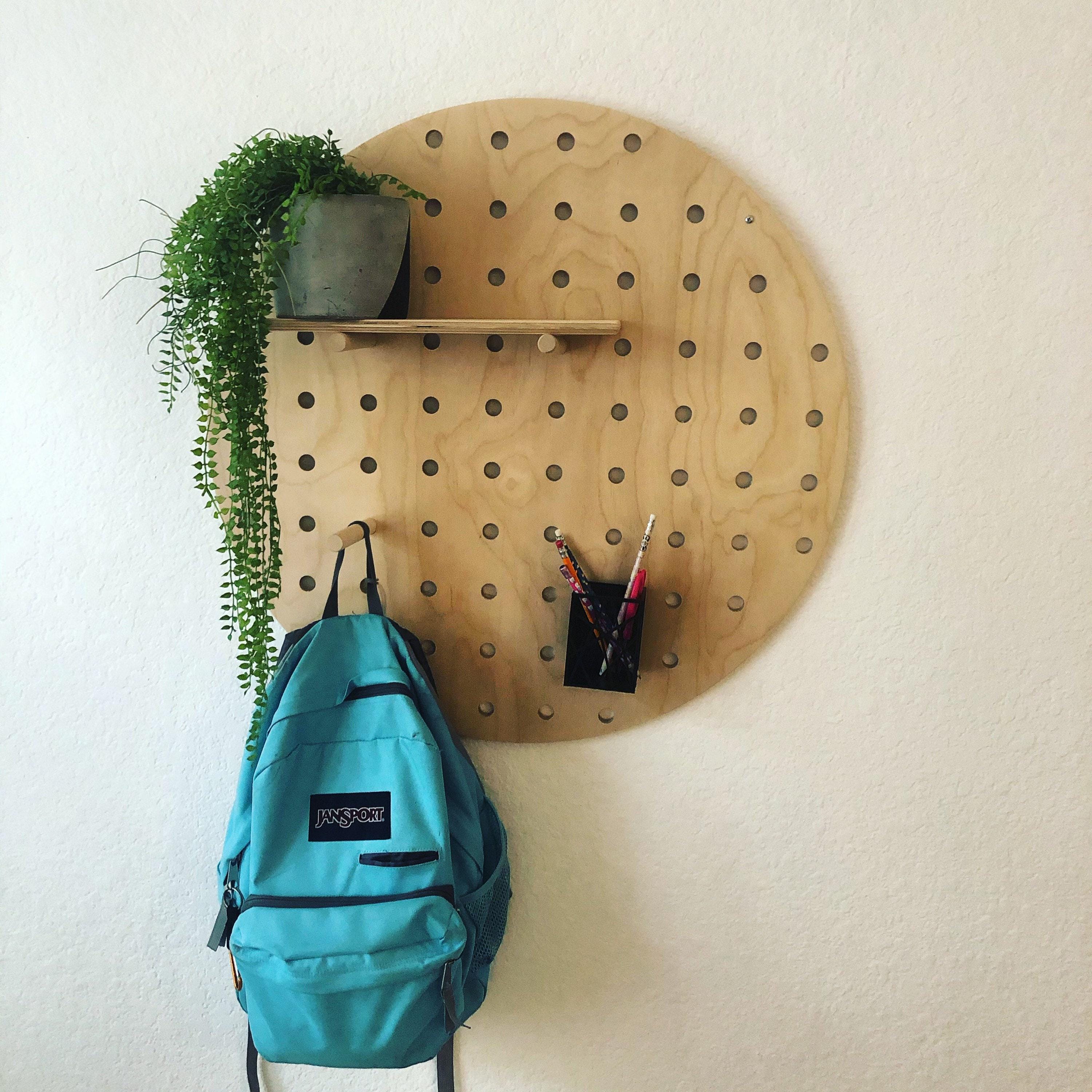 Circle wood pegboard display styled with shelves and decor, CNC cut in our shop