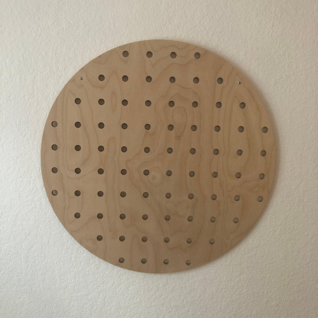 Round wooden pegboard wall display, product view, CNC cut in our shop