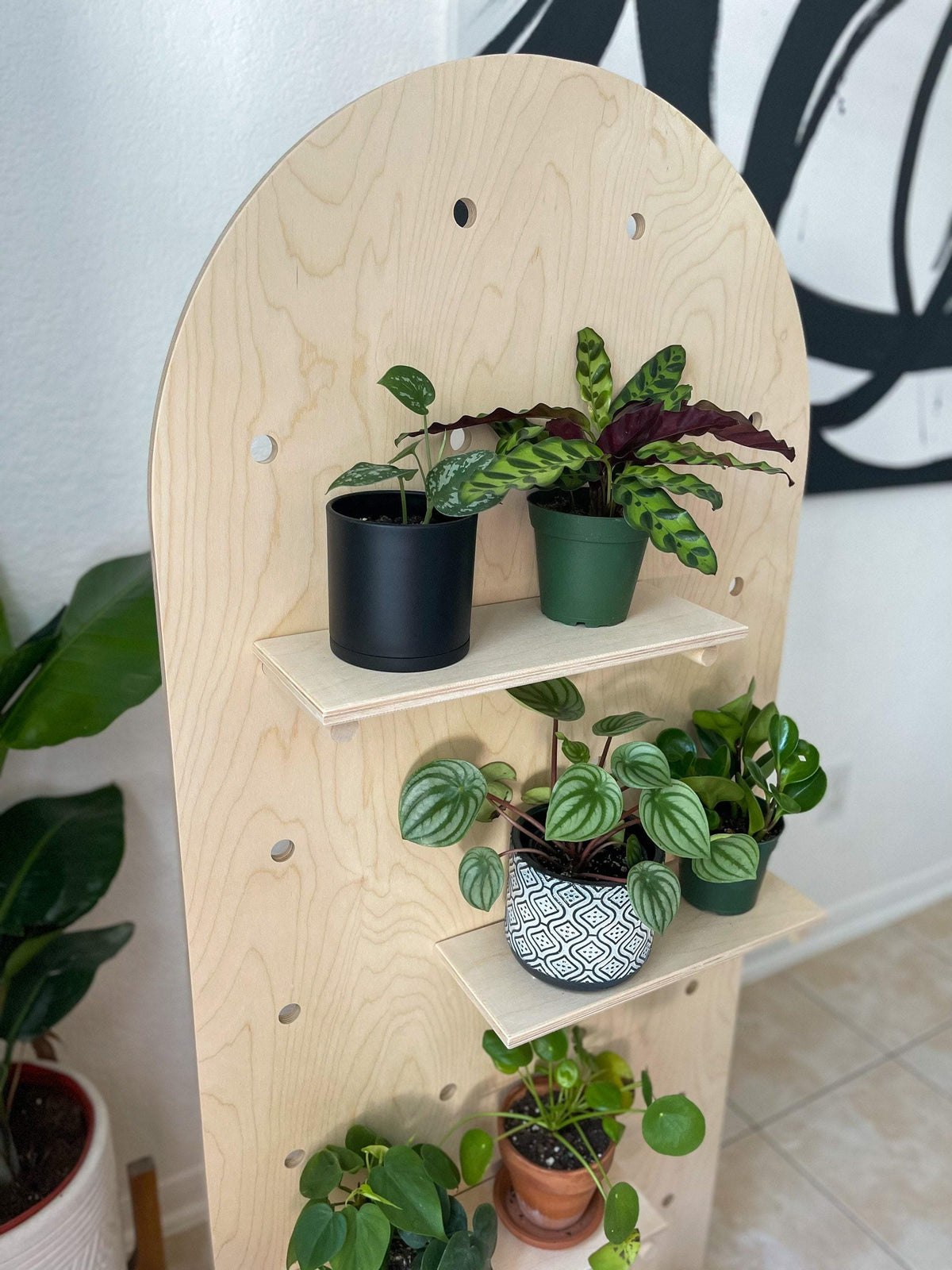 Freestanding curved pegboard stand, back view, CNC cut in our shop