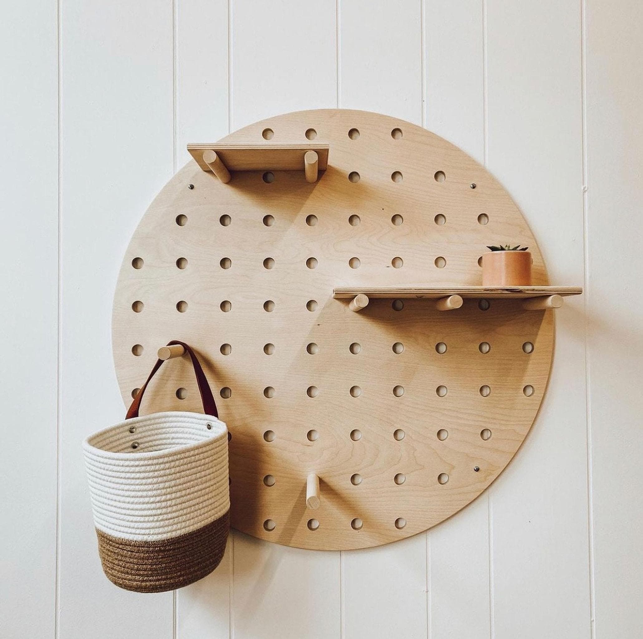 Round birch plywood pegboard wall display with floating shelves, updated hero photo, CNC cut in our shop