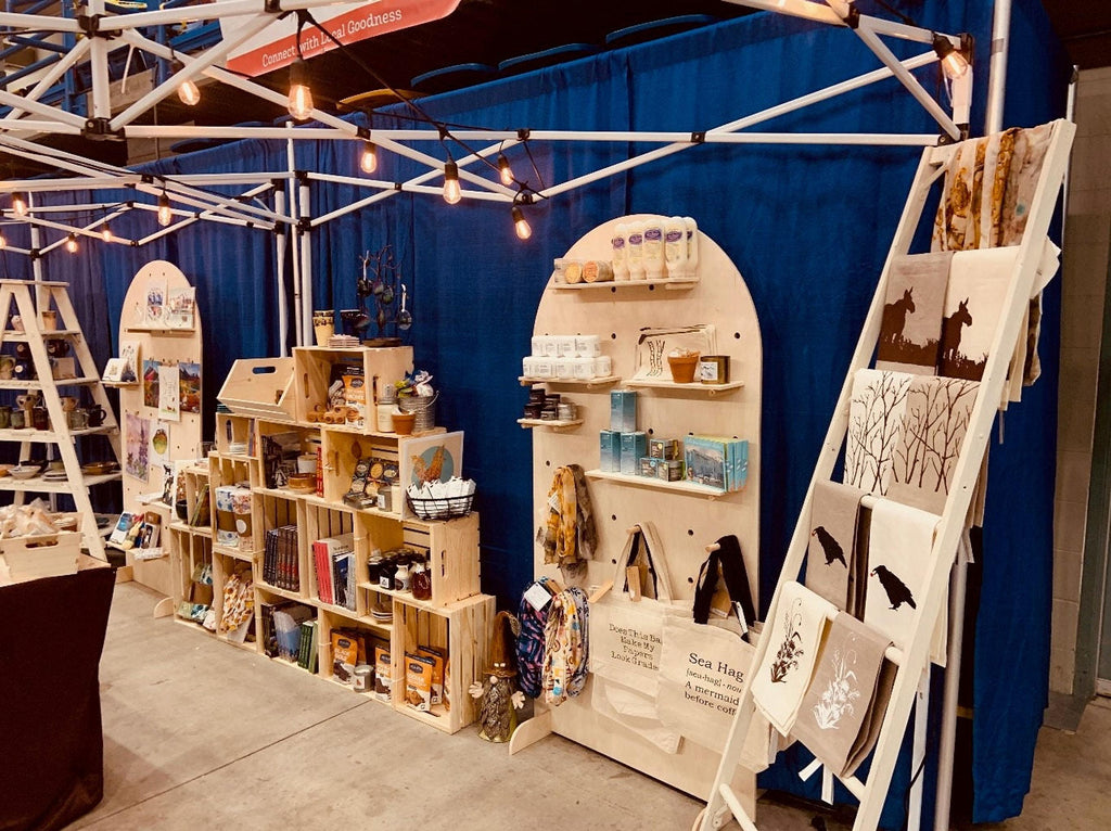 Freestanding curved plywood pegboard retail fixture, styled view, CNC cut in our shop
