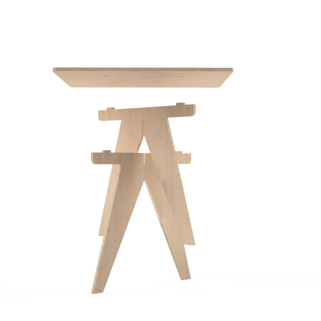 Underside view of flat-pack birch plywood square table showing interlocking V-leg joinery detail, CNC cut in our shop